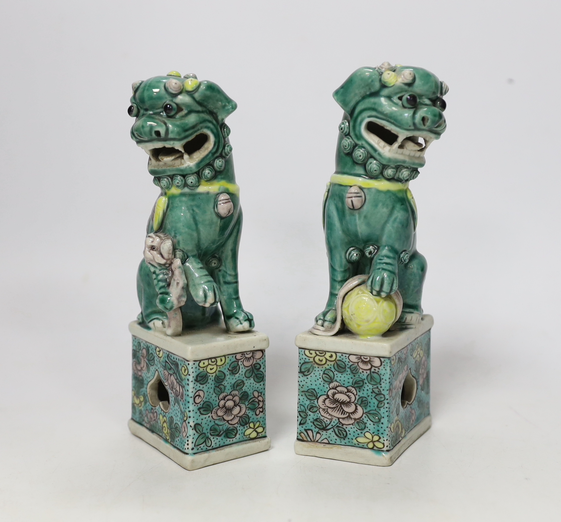 A pair of small early 20th century Chinese figures of Buddhist lions, 15.5cm high